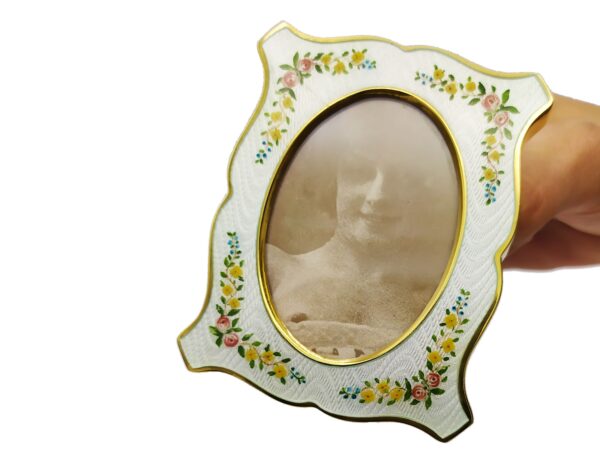 Salimbeni1891 Shaped Photo Frame in Sterling Silver with fired White enamels on guilloche and hand painted floral miniatures. 3 scaled